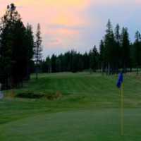 A view of green with narrow road on the left at Sparwood Golf Club